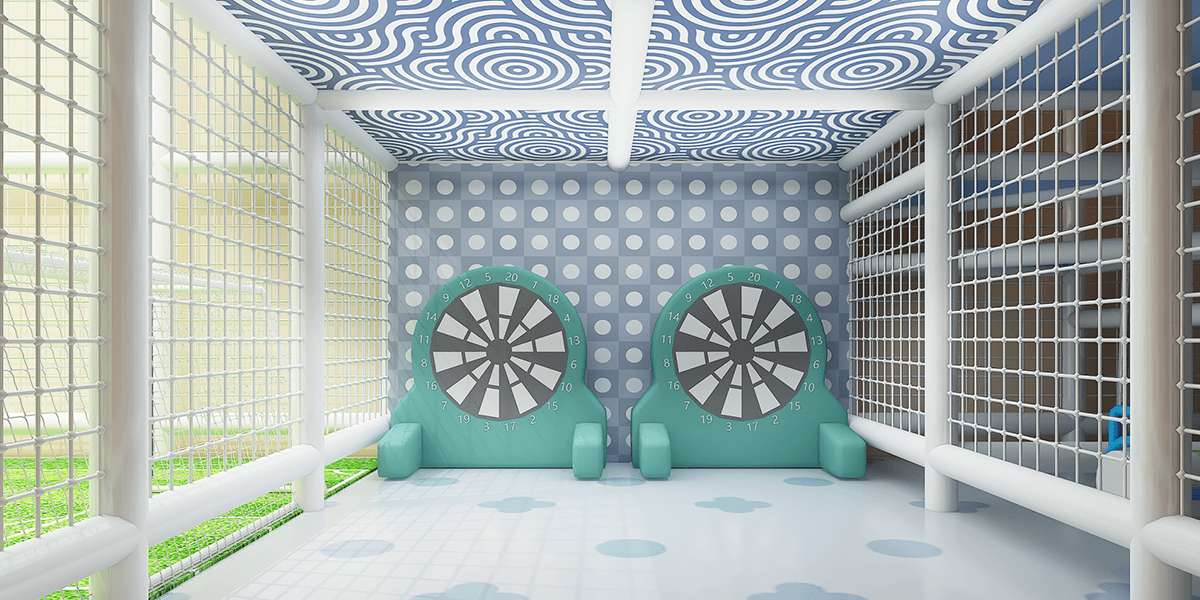 Colorful play area with two dartboard targets, circular patterns on the walls, and protective mesh surrounding the space.