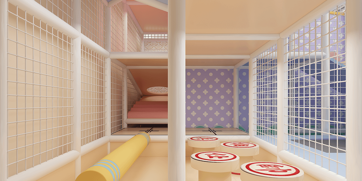 Inside view of a colorful play structure with soft mats, yellow roller, and patterned walls behind protective mesh.